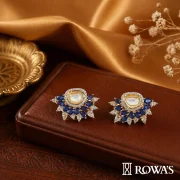 Aurora Majestic Gross wt – 18.96 gms Gold wt – 16.94gms Polki – 1.28cts Diamonds – 3.13cts Blue sapphire – 5.70cts These earrings embody the regality and opulence of blue sapphires paired with glistening diamonds. The sophisticated design reflects the timeless elegance of royalty, perfect for making a grand entrance at any formal event.