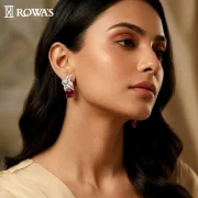 Blazing Petals Earrings Gross wt – 16.71 gms Gold Wt – 13.15 gms Diamonds – 2.36 cts Ruby wt – 9.74 cts Yellow Citrine wt – 5.72 cts These earrings are inspired by the fiery petals of an exotic bloom. The vibrant rubies and diamonds are arranged in a floral pattern, capturing the essence of nature’s fierce beauty. Ideal for those who wish to make a bold and striking impression.