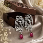 Garden of Eden Earrings in Rosecut Diamonds Gross wt – 23.67 gms Gold wt – 19.63 gms Diamonds – 1.28 cts Rosecuts – 2.44 cts Ruby – 16.48 cts Inspired by the lush and enchanting beauty of the mythical Garden of Eden, these Earrings features cascading ruby beads that symbolize the abundance of nature. The intricate diamond floral motifs represent the garden’s exquisite blooms, creating a harmonious blend of natural beauty and luxury. This piece is perfect for those who appreciate the elegance and wonder of a paradisiacal garden.